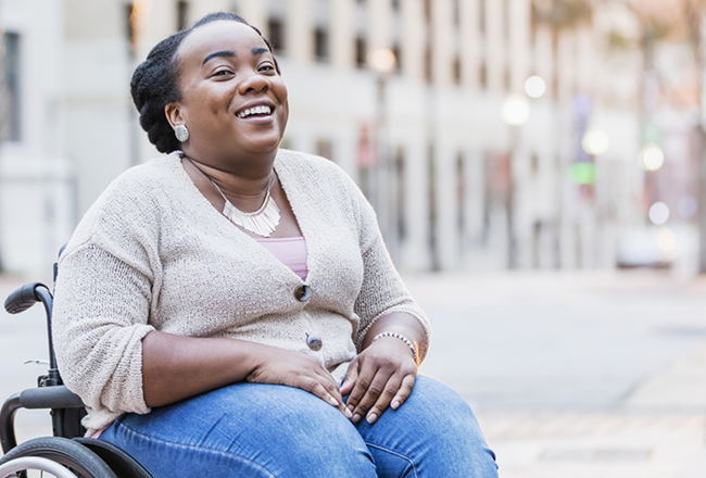 Care that fits around your routine A smiling woman in a wheelchair, showcasing joy and positivity in her expression