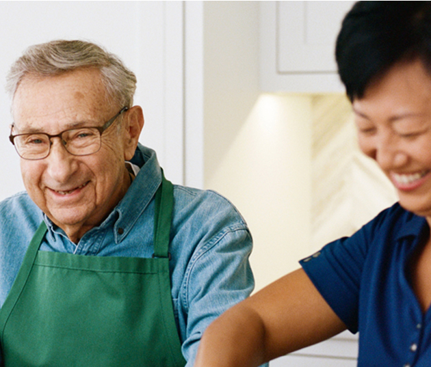 Who can benefit from hourly care at home A woman and an older man are collaborating in the kitchen, preparing ingredients for a meal together